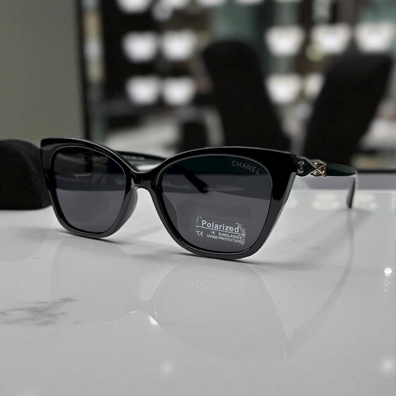 Sleek Black Chanel Cat-Eye Sunglasses with Gold Accents