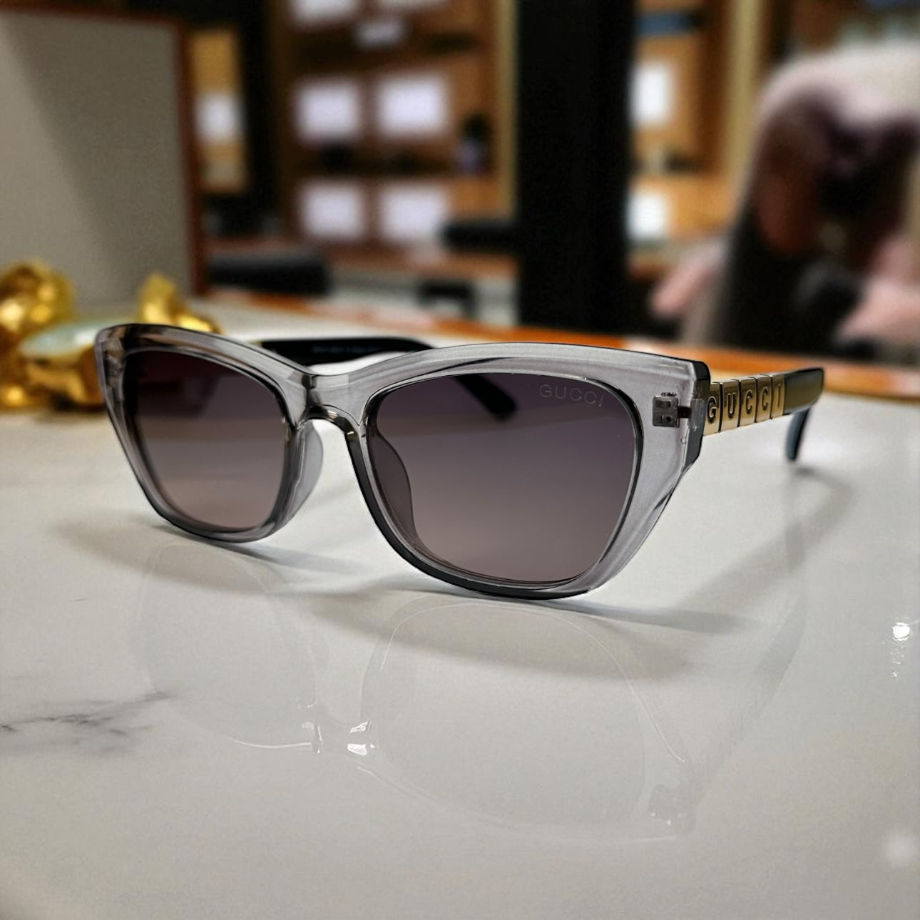 Bold Clear-Grey Cat Eye Sunglasses with Gold Logo Temple Detail
