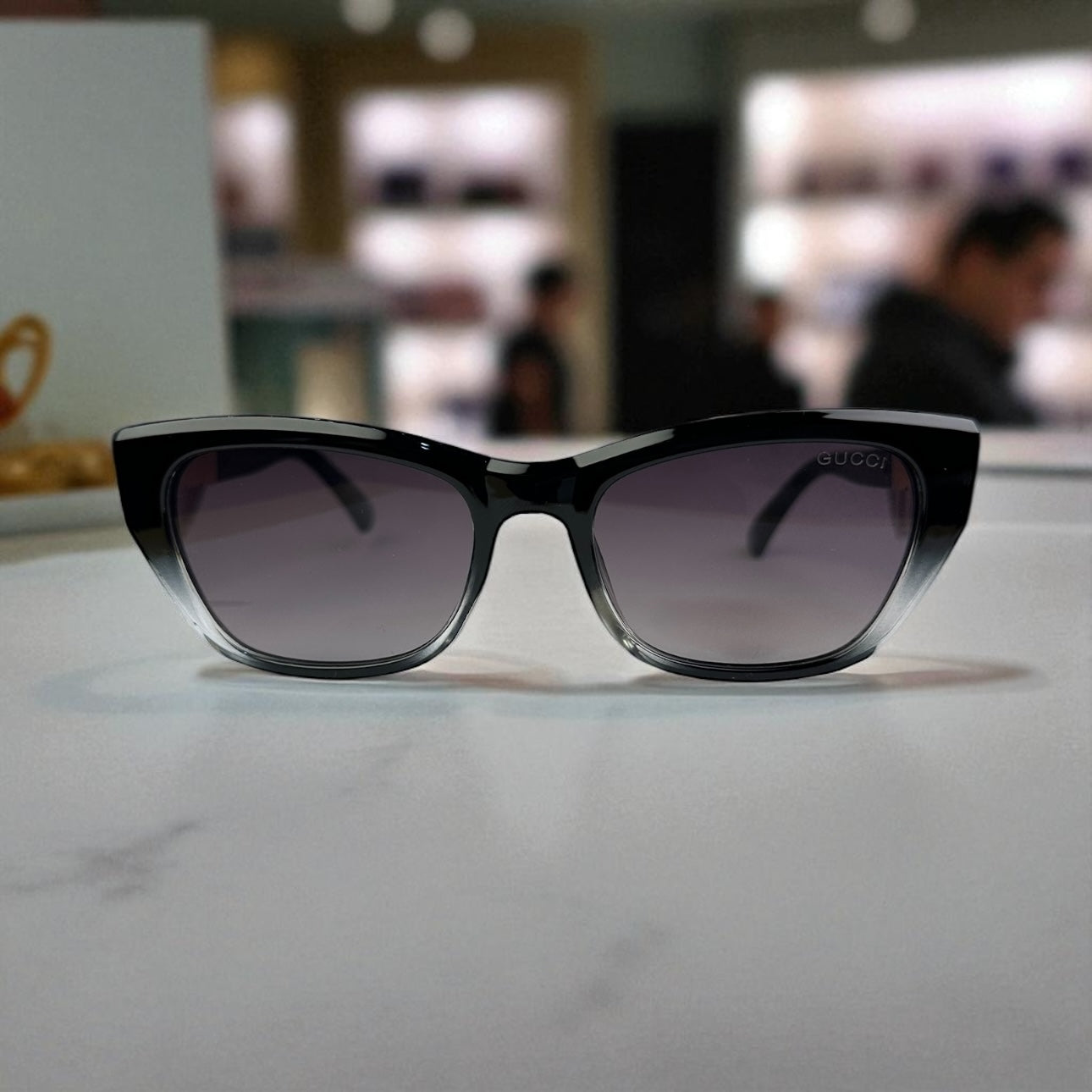 Striking Black-to-Clear Cat Eye Sunglasses with Gold Logo Temple