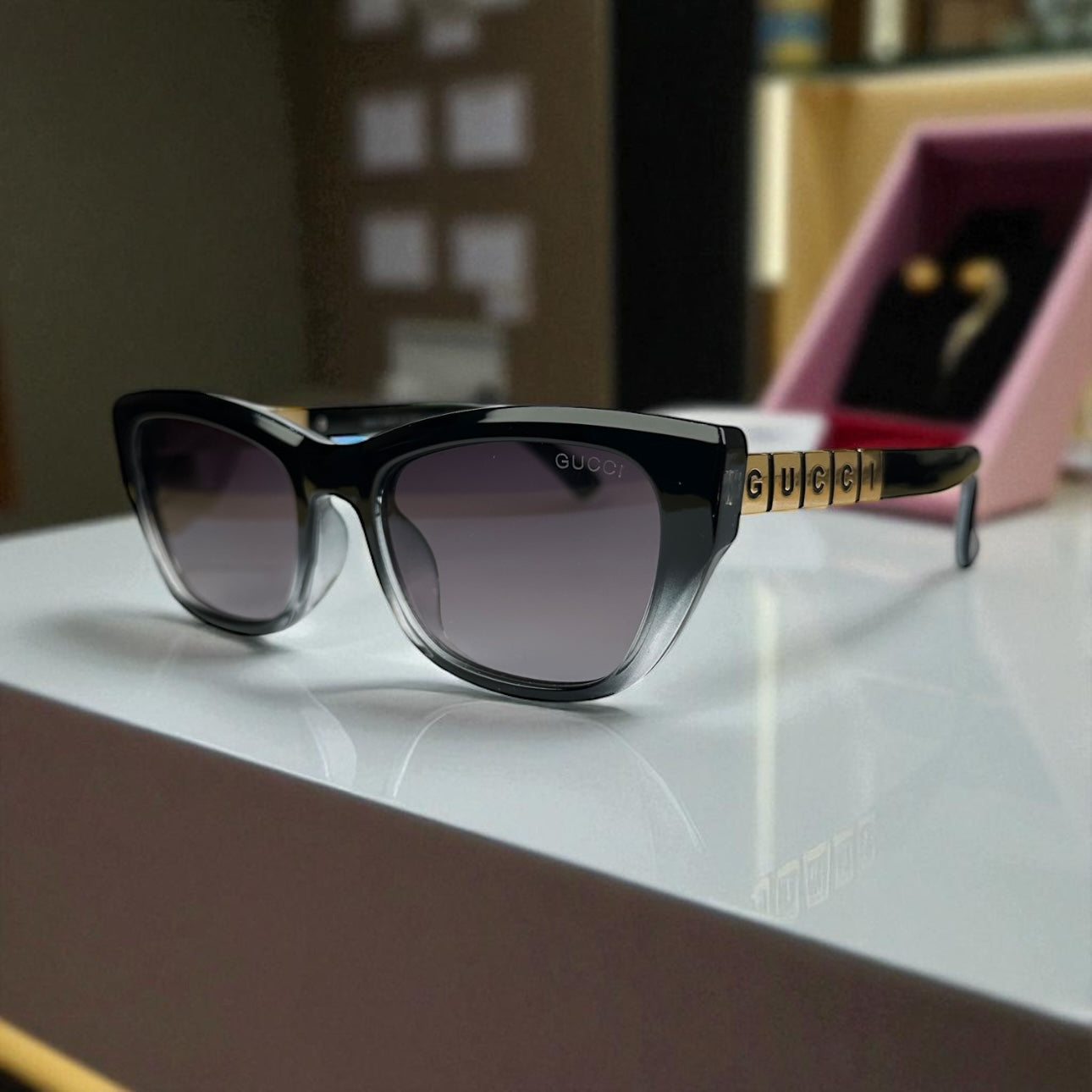 Striking Black-to-Clear Cat Eye Sunglasses with Gold Logo Temple