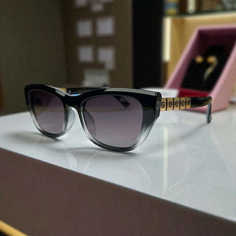 Striking Black-to-Clear Cat Eye Sunglasses with Gold Logo Temple