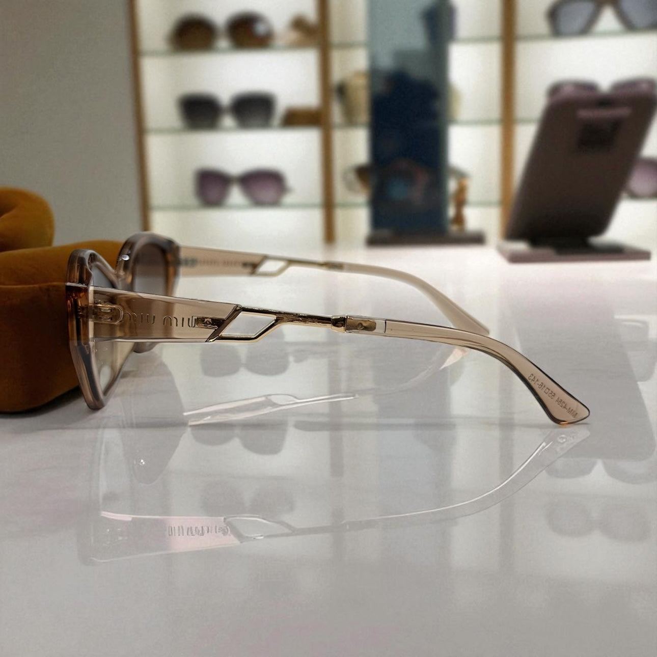 Miu Miu Cat-Eye Polarized Sunglasses – Nude Gradient Frame with Gold Detail UV400